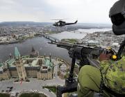 Canadian Air Force pilot in CH-146 Griffon helicopter flies over Parliament Hill