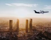A hydrogen-powered regional aircraft flies over Madrid