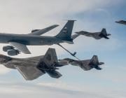 F-22 fighters and KC-135 tankers in flight