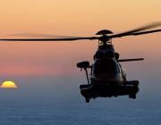 Helicopter flying against sunset