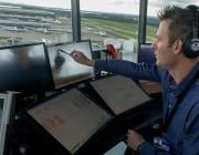 Air traffic controller in tower at London Heathrow Airport