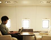 a business jet passenger working on a laptop