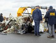 Accident investigators survey wreckage from the Bell 206L-4 that crashed in the Hudson River. 