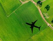 airplane flying over green grass