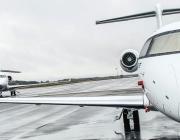 Bizjets on a runway in the rain