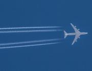 contrails in the sky along with an airplane