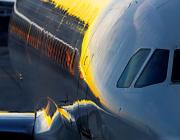 sunset shining light on the fuselage of an airplane