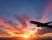 colorful sunset with the silhouette of a passenger plane