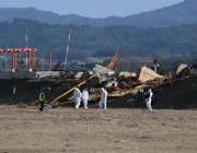 investigators at the site of a Jeju Air crash