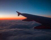 The wing of an airplane in a sunset