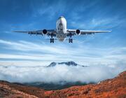 generic airplane over mountain and cloud