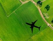 airplane flying over green land