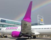 caribbean airlines jet with rainbow in background