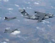 KC-390 refueling two Saab Gripen Es behind it