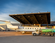 an aircraft next to a Million Air SAF truck