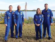 four astronauts standing