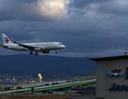A China Eastern passenger aircraft lands at Kansai International Airport on December 04, 2025 in Osaka, Japan