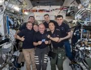 iss073e1198029 (Nov. 27, 2025) --- The seven-member Expedition 73 crew gathers together for a portrait inside the International Space Station's Kibo laboratory module celebrating NASA astronaut Mike Fincke's (center) 500 cumulative days in space over four missions since 2004. In the front from left are, Roscosmos cosmonaut Sergey Ryzhikov, NASA astronaut Zena Cardman, Mike Fincke, and NASA astronaut Jonny Kim. In the back are, JAXA (Japan Aerospace Exploration Agency) astronaut Kimiya Yui and Roscosmos cosm