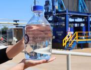 hands of a person holding a bottle of syn fuel.