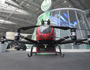 an adapted Chinese Ehang eVTOL aircraft equipped to fight urban blazes from above