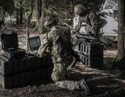 Soldiers in field with UAV