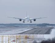 aircraft landing on runway with snow