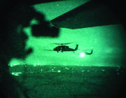 helicopters over city seen through night vision goggles