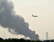 emirates jet flying over dubai airport