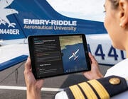 person looking at Navi on a tabletnext to an Embry-Riddle aircraft