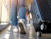 Traveler walking with a suitcase at an airport