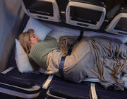person sleeping on row of three seats
