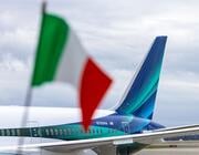 alaska airlines tail fin with italian flag in the foreground