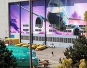 Boeing factory with 737 fuselages and a mural on the wall