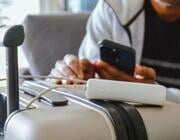 power bank charging cellphone on luggage