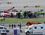 March 25, 2026, Queens, New York, Usa: (NEW) Airport maintenance crews position a tow truck as they prepare to move the wreckage of a Port Authority firetruck from the runway where it had collided with an Air Canada Express jet