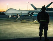 person standing by MQ-9 Reaper