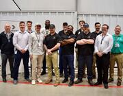 Students and instructors participating in Bombardier’s FastTrack course pose at the manufacturer’s service center at Bradley International Airport. 