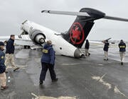 NTSB investigators around damaged Air Canada jet