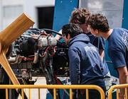 aviation maintenance students studying an aircraft engine