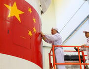 Chinese engineers check spacecraft fairing