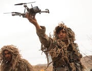 soldiers in the field with drones