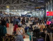 Passengers queue at airport
