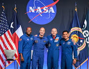 Andre Douglas, Luca Parmitano, Randy Bresnik and Frank Rubio pose in front of flags