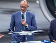 German Chancellor Friedrich Merz addresses ILA Berlin 2026 as Airbus CEO Guillaume Faury watches on.