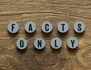 wooden circular tiles reading "facts only" 