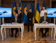 Ukrainian government Pic caption: Flanked by images of Gripen Es armed with Meteor and IRIS-T missiles, Swedish and Ukrainian officials sign the first order for new Saab fighters by Kyiv.