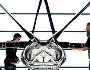 two people standing by 3D-printed aircraft fuselage