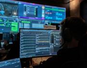 person looking at computer loading the software that guides Jackal spacecraft