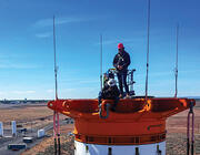 two workers standing on rocket