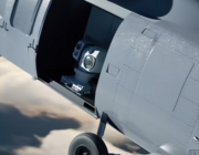 helicopter with an open side bay revealing a laser